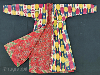 An elegant Antique Uzbek Ikat Robe Chapan  from Bokhara / Bukhara. It is an adras Ikat (silk warp/cotton weft) from early third quarter of the19th Century. The design is relatively unique  ...