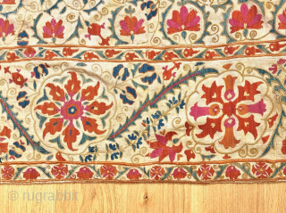 A stunning mid-19th century Antique Uzbek Bukhara Suzani, showcasing exceptionally fine silk embroidery on a linen Karbos ground. This large-scale masterpiece features chain-stitched and basma/flat stitch techniques. The vibrant field design displays  ...