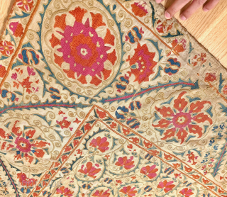 A stunning mid-19th century Antique Uzbek Bukhara Suzani, showcasing exceptionally fine silk embroidery on a linen Karbos ground. This large-scale masterpiece features chain-stitched and basma/flat stitch techniques. The vibrant field design displays  ...