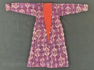 A dazzling antique Uzbek silk on silk Atlas / abr Ikat Chapan / Robe dating to the 3rd quarter of the 19th century. It has an archaic design consisting of repeating ornamental  ...