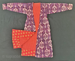 A dazzling antique Uzbek silk on silk Atlas / abr Ikat Chapan / Robe dating to the 3rd quarter of the 19th century. It has an archaic design consisting of repeating ornamental  ...