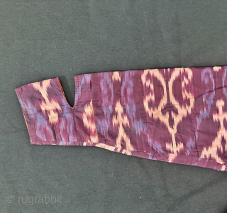 A dazzling antique Uzbek silk on silk Atlas / abr Ikat Chapan / Robe dating to the 3rd quarter of the 19th century. It has an archaic design consisting of repeating ornamental  ...