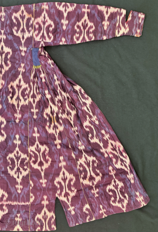 A dazzling antique Uzbek silk on silk Atlas / abr Ikat Chapan / Robe dating to the 3rd quarter of the 19th century. It has an archaic design consisting of repeating ornamental  ...