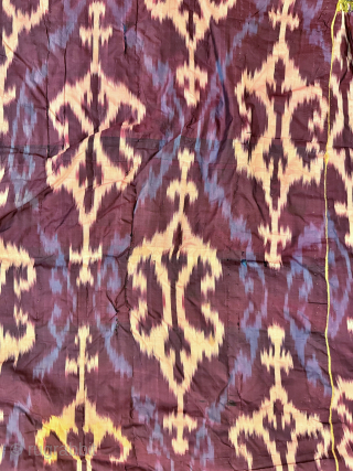 A dazzling antique Uzbek silk on silk Atlas / abr Ikat Chapan / Robe dating to the 3rd quarter of the 19th century. It has an archaic design consisting of repeating ornamental  ...