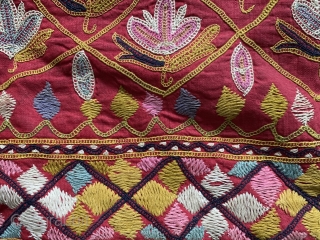 A fine antique Indian silk embroidered hanging from Gujarat (turned into a functional pillow). It dates around 1900  and is a really fine work of textile art. The red field is  ...