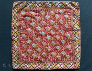 A fine antique Indian silk embroidered hanging from Gujarat (turned into a functional pillow). It dates around 1900  and is a really fine work of textile art. The red field is  ...