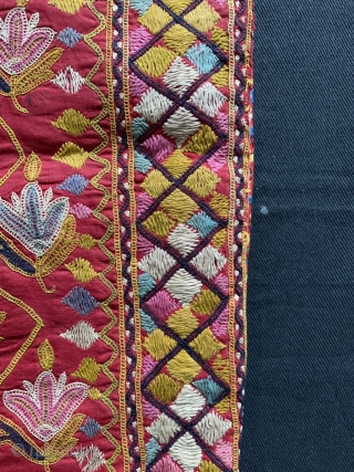 A fine antique Indian silk embroidered hanging from Gujarat (turned into a functional pillow). It dates around 1900  and is a really fine work of textile art. The red field is  ...