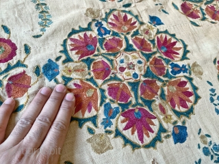 An excellent antique Uzbek silk suzani from Nurata dating between mid and early 3rd quarter of 19th century. Boasting a rich floral field design embroidered using fine polychrome silks chain-stitched on a  ...