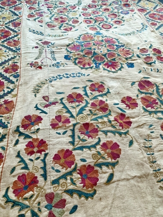 An excellent antique Uzbek silk suzani from Nurata dating between mid and early 3rd quarter of 19th century. Boasting a rich floral field design embroidered using fine polychrome silks chain-stitched on a  ...