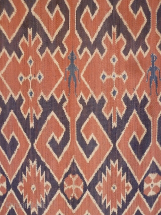 A Toraja Sulawesi ceremonial cloth, joined cotton lengths in warp ikat technique. Indonesia, mid 20th Century. Note the human figures interspersed between the geometric motifs.        