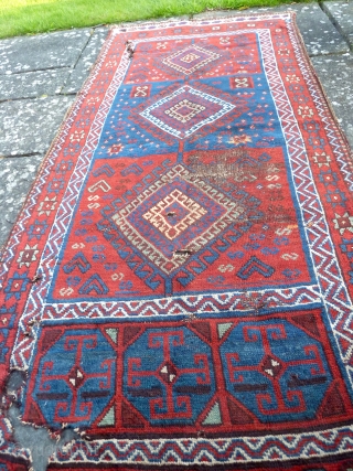 A good 19th Century Shavak anatolian rug, with lustrous wool and saturated natural colours. Damaged as seen - needs washing and conservation/repair. 240 x 108 cm.       