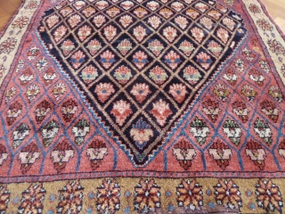 An unusual Northwest Persian rug, early 20th Century. Flower filled lattice design. Repair at one end, otherwise great condition. All good colours and very soft wool. 190 x 137 cm   