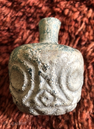 Jade green, thick walled Sassanian glass bottle.  Ancient Near East/Central Asia, Sassanid Empire.  Probably 5th century A.D.  Size: 3.25 x 2.50 inches. Deeply cut faceted design.  Typical pearlescent  ...