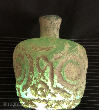 Jade green, thick walled Sassanian glass bottle.  Ancient Near East/Central Asia, Sassanid Empire.  Probably 5th century A.D.  Size: 3.25 x 2.50 inches. Deeply cut faceted design.  Typical pearlescent  ...