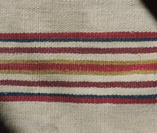 A unique, white ground Aymara Ponchito (small poncho). Altiplano region, Bolivia. Early 19th Century or before. One of a kind cotton and alpaca man's ceremonial overgarment. The only ponchito of the type  ...