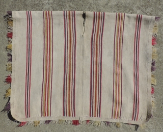 A unique, white ground Aymara Ponchito (small poncho). Altiplano region, Bolivia. Early 19th Century or before. One of a kind cotton and alpaca man's ceremonial overgarment. The only ponchito of the type  ...