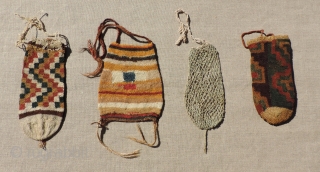 Group of four small Pre-Columbian pouches.  B.C. 100 - A.D. 400.  Size: Largest is 7.5 inches tall.  Sold as a group or individually.  Reasonable.     