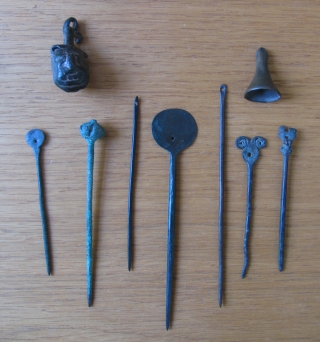 Collection of Pre-Columbian Bronze and Silver objects.  Dating from AD 500 to the Inca period.  This group includes silver and bronze textile pins (tupus) small pendants, needles, bells and one  ...