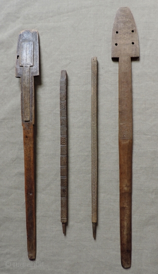 Albanian distaffs and other carved wooden weaving implements.  19th century. longest piece 37 x 4 inches.                