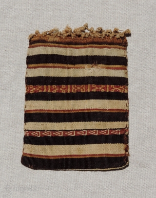 This small, finely woven Incan period tapestry bag has different designs on each face. It has a subtle checkerboard background with two coca leaf motifs or eye symbols worked in eccentric wefts  ...