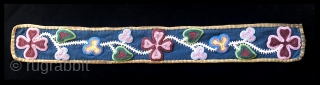 19th century Great Lakes bandolier bag strap.  Possibly Ojibwe tribe. Nine different colors of seed beads decorate this strap. The beads are sewn to a dark blue woolen trade cloth background  ...