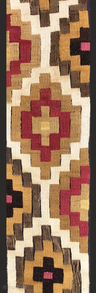 Very beautifully woven Pre-Columbian slit tapestry strip.  Chimu Culture, Peru.  A.D. 1000 - 1400.  The textile has been sewn to a black backing cloth and attached to a frame  ...