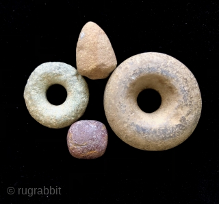 Ancient Andean stone implements.  A.D. 500- 1400's.  The stone discs (Andean Bagels) were used as mace heads or hammer stones when coupled with a wooden handle inserted through the center.  ...