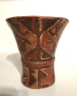 Ancient Andean drinking vessel known as a hero. A.D 800 - 1100.  Ceramic cups in this flared shape were made for the consumption of  alcoholic beverages during ritual occasions.   ...