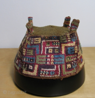 Andean pile headdress.  Wari culture (500 - 800 AD).  This is an excellent "four cornered hat" with interlocked caiman-like depictions. Black Caiman are the largest predators in South America. They  ...