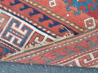 Kazak rug, Caucasian- beautiful old triple medallion rug with red field and guards giving a classic 'floating effect' with the delicate balance between motifs and red ground; this effect is compounded by  ...