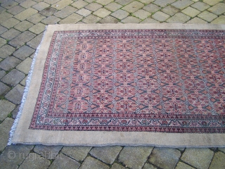 Serab/Bakshaish long rug- North-West Persian, camel ground with field having allover flowerhead lattice enclosed by flowerhead (carnation) and diagonal main border with reciprocal 'Y' guards. Colours: camel, red, green, indigo, blue, pink,  ...