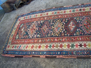 Karabagh runner - blue field with single column of hooked diamonds enclosed by ivory main border, early 20th.century; contains a synthetic pink-red (not the inner border colour but detailing in hooked diamonds  ...