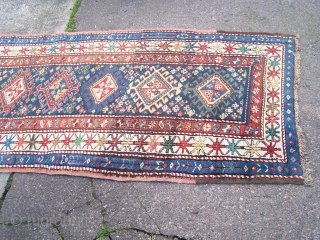 Karabagh runner - blue field with single column of hooked diamonds enclosed by ivory main border, early 20th.century; contains a synthetic pink-red (not the inner border colour but detailing in hooked diamonds  ...