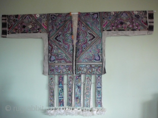 "Hunderd-bird" Coat of Miao minority, Rongshui style. Quizhou, south China

Collarless jacket with sleeves and a"skirt" of twelf free-hanging panels. The jacket is supposed to be part of a shaman's costume. It was  ...