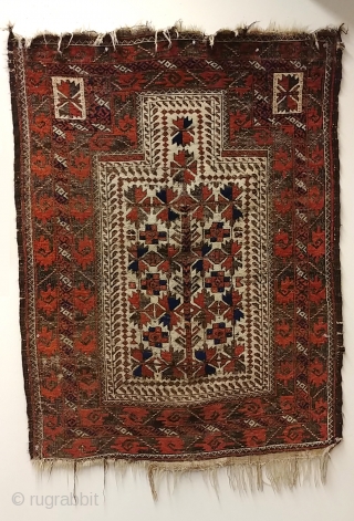 Antique Baluch prayer rug. Glossy camel field with saturated madder red in high relief, deep indigo highlights, and heavily oxidized browns, combining to form a rug of striking, sculpted presence.  Displays  ...