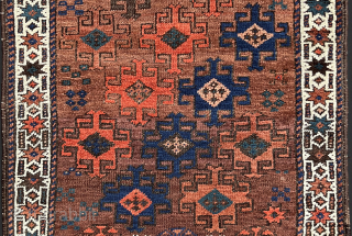 Antique Baluch. Saturated color in a wide palette on a ground of burnt-umber, largely undyed wool. In high pile with the exception of some slightly corroded browns. The gloss of ...