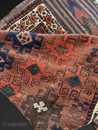 Antique Baluch. Saturated color in a wide palette on a ground of burnt-umber, largely undyed wool. In high pile with the exception of some slightly corroded browns. The gloss of ...