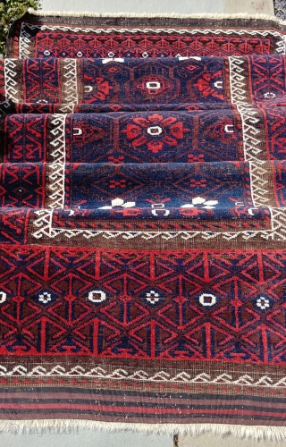 Antique Mina Khani Baluch. 254cm x 90 cm (8'3" x 3') Cherry red and deep navy blue. Unusual borders with long knotted elems.  Camel wefts.  Corroded blacks in the border.  ...