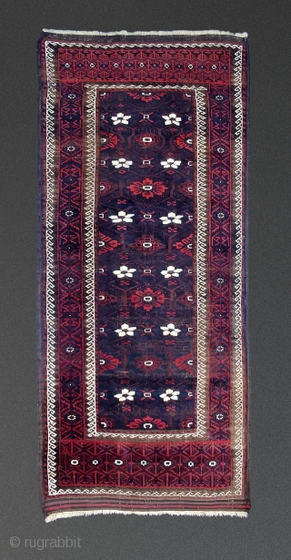 Antique Mina Khani Baluch. 254cm x 90 cm (8'3" x 3') Cherry red and deep navy blue. Unusual borders with long knotted elems.  Camel wefts.  Corroded blacks in the border.  ...