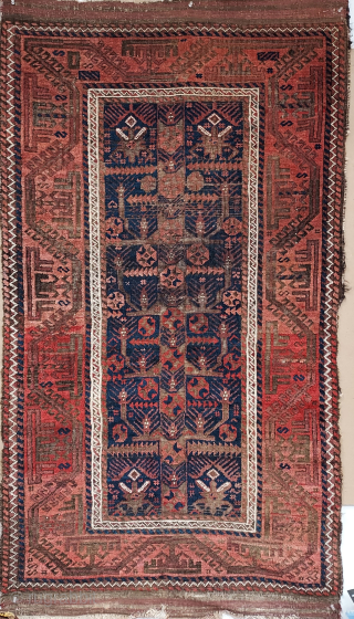 Antique Baluch rug with Rare Tree and stylized garden design on Deep Indigo ground, 34 x 64 inches. Lush pile with uneven wear and corroded browns; rough passages at sides stabilized by  ...