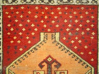 Anatolian yastik with amber hexagon spaceship medallion soaring over star-studded crimson field.  51 x 74 cm. -- Late 19th century.            