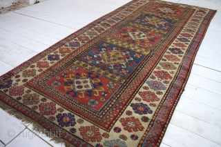 An antique south Caucasian rug of quite large proportions - 284 x 130cm.    Good vegetable dyes.    Very dirty.    Damaged and worn in places  ...