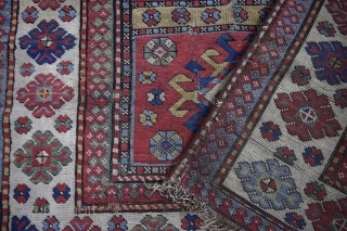 An antique south Caucasian rug of quite large proportions - 284 x 130cm.    Good vegetable dyes.    Very dirty.    Damaged and worn in places  ...