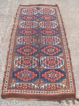 An East Anatolian 'Memling Gul' rug, probably mid 19th century, 245 x 111cm.  Deep, saturated colours.  Corroded brown and some damage.   Feels early.      