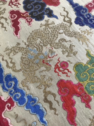 A Qing Dynasty embroidery brocade from China in the early 19th century

On the white silk and satin, the silk is weaved with colorful silk thread, and the golden dragon is weaved with  ...