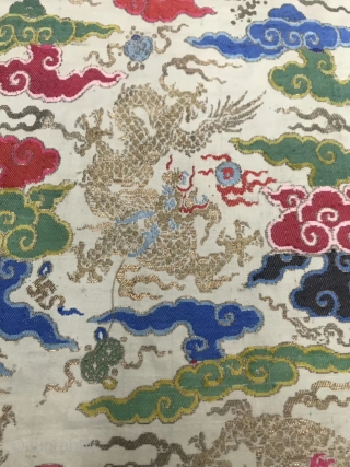 A Qing Dynasty embroidery brocade from China in the early 19th century

On the white silk and satin, the silk is weaved with colorful silk thread, and the golden dragon is weaved with  ...