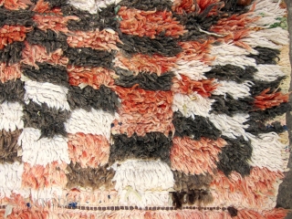 Moroccan Boujad,length 280cm plus 10cm fringe, width varying between 150 and 158cm.
Pile is formerly red, faded to lovely terracotta, white and black and natural brown wool. Repaired with whatever boucherouite material was  ...