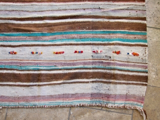 SOLD - A ca. 1970 Moroccan hanbel with a field striped in earth tones and pops of color in turquoise, tangerine and more. Minimal pattern of pile construction. 
Weft is wool -  ...