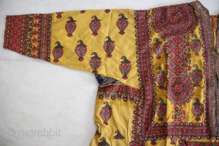 A wonderful example of Mochi embroidery from Kutch, Gujarat. This yellow satin silk wedding coat is beautifully decorated in chain stitch all over to depict parrots and floral motifs. The front pocket  ...