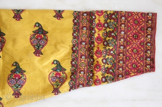 A wonderful example of Mochi embroidery from Kutch, Gujarat. This yellow satin silk wedding coat is beautifully decorated in chain stitch all over to depict parrots and floral motifs. The front pocket  ...